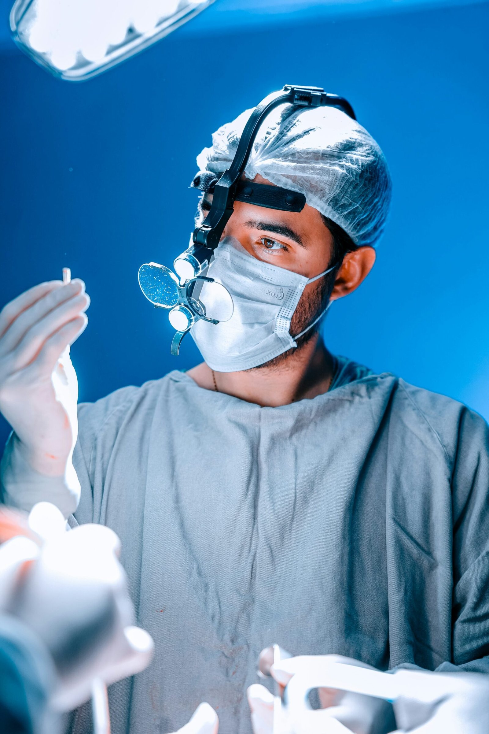Surgeon examining a medical instrument during surgery