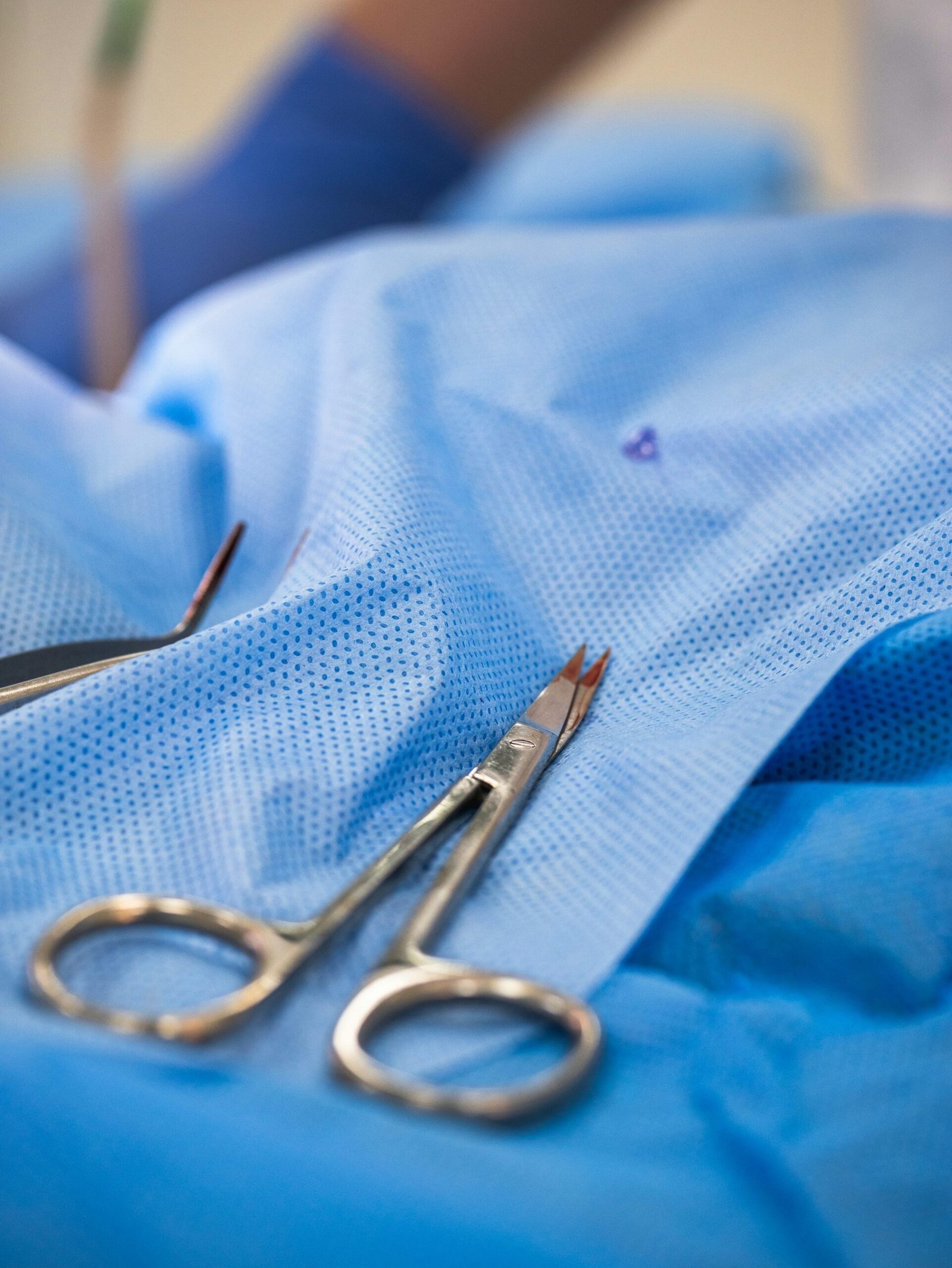 Surgical instruments arranged on a sterile blue drape